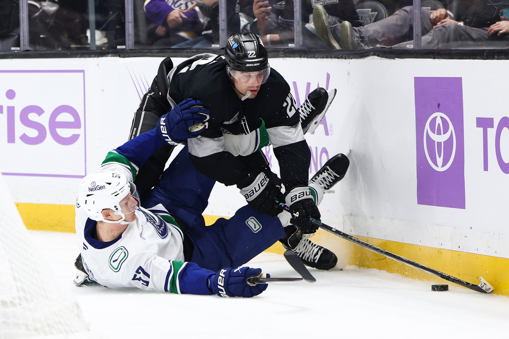 Los Angeles Kings left wing Kevin Fiala, right, trips over Vancouver Canucks defenseman Tyler Myers (57) during the second period of an NHL hockey game, Saturday, Nov. 29, 2025, in Los Angeles. (AP Photo/Jessie Alcheh)