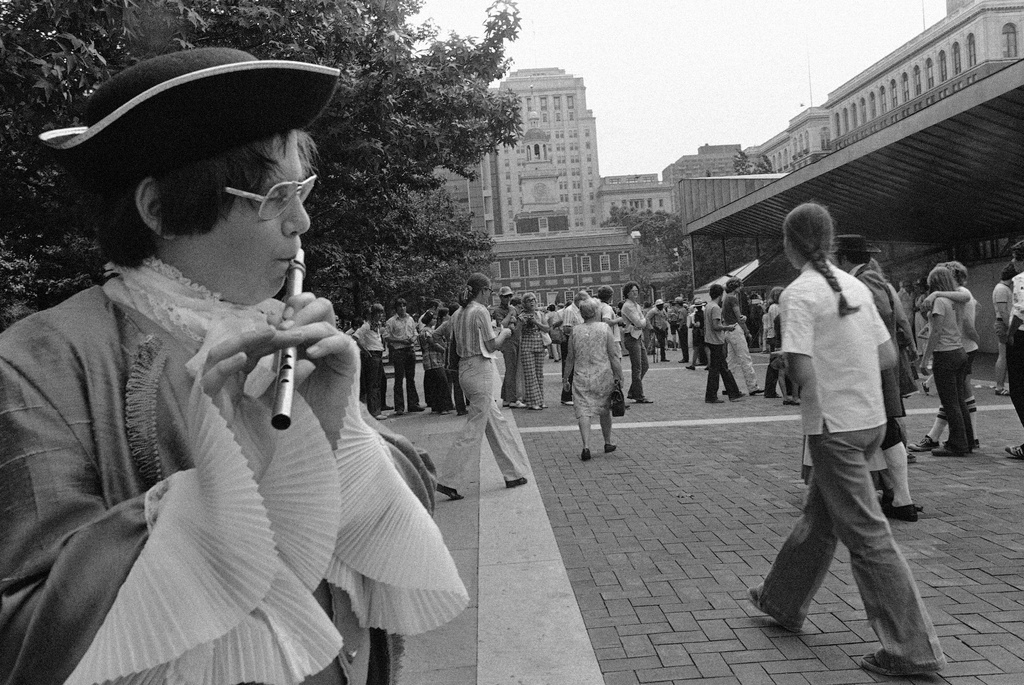 FILE - A young flute player in colonial costume plays "Yankee Doodle" for crowds gathering to visit the Liberty Bell in Philadelphia, July 3, 1976. (AP Photo/Bill Ingraham, File)