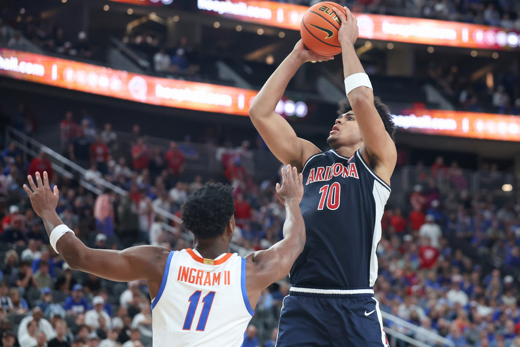 Arizona forward Koa Peat (10) shoots against Florida guard CJ Ingram (11) during the second half of an NCAA college basketball game, Monday, Nov. 3, 2025, in Las Vegas. (AP Photo/Ian Maule)