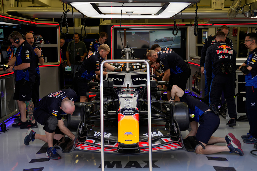 Mechanics of Red Bull driver Max Verstappen of the Netherlands prepare his car during a Formula One pre-season test at the Bahrain International Circuit in Sakhir, Bahrain, Wednesday, Feb. 11, 2026. (AP Photo/Altaf Qadri)