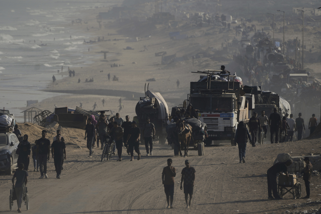 Displaced Palestinians flee Gaza City by foot and vehicles, carrying their belongings along the coastal road toward southern Gaza, Wednesday, Sept. 17, 2025. (AP Photo/Abdel Kareem Hana)