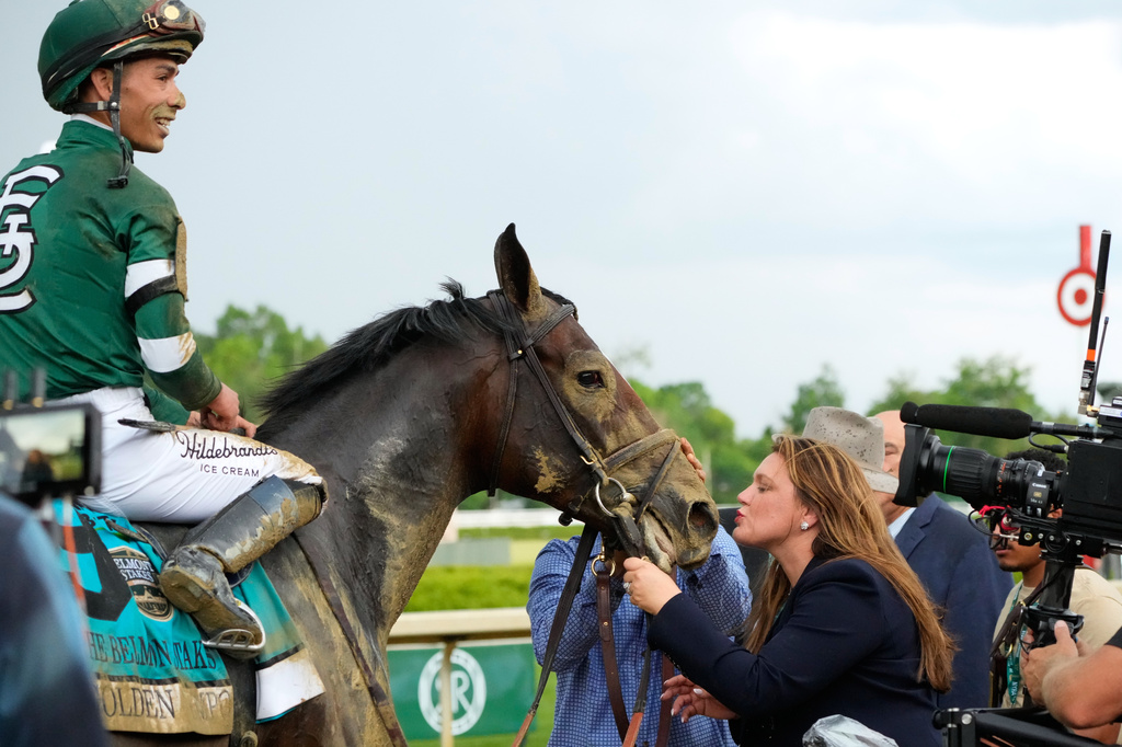 Trainer Cherie DeVaux, right, greet Golden Tempo (9) and Jockey Jose Ortiz after they won the 158th running of the Belmont Stakes horse race, Saturday, June 6, 2026, in Saratoga Springs, N.Y. (AP Photo/Yuki Iwamura)
