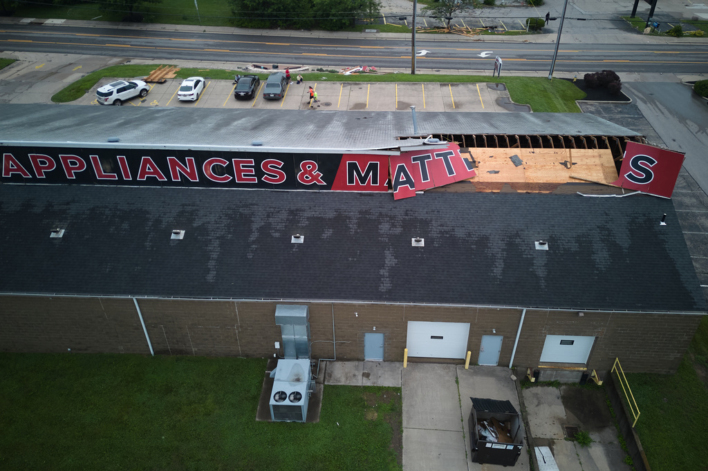 Roof and sign damage are seen at Big Red Appliances & Mattresses in Florence, Ky, Thursday, June 18, 2026, after severe weather moved through the region. (AP Photo/Carolyn Kaster)
