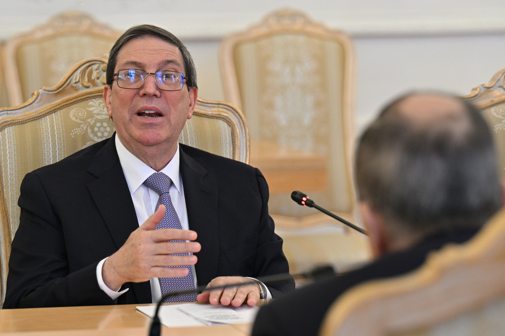 Cuban Foreign Minister Bruno Rodriguez, left, gestures while speaking to Russian Foreign Minister Sergey Lavrov, back to a camera, during their meeting in Moscow, Russia, Wednesday, Feb. 18, 2026. (Hector Retamal/Pool Photo via AP)