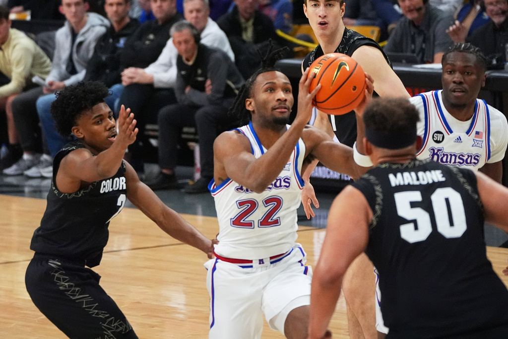 Kansas guard Darryn Peterson, center, drives the lane between Colorado guard Isaiah Johnson, left, and center Elijah Malone in the first half of an NCAA college basketball game Tuesday, Jan. 20, 2026, in Boulder, Colo. (AP Photo/David Zalubowski)