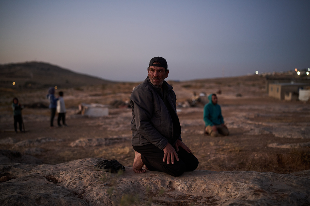 Thalib prays along with other Palestinian men at dusk in their community near the West Bank village of Susya, in the Masafer Yatta region, Wednesday, June 17, 2026.(AP Photo/Leo Correa)