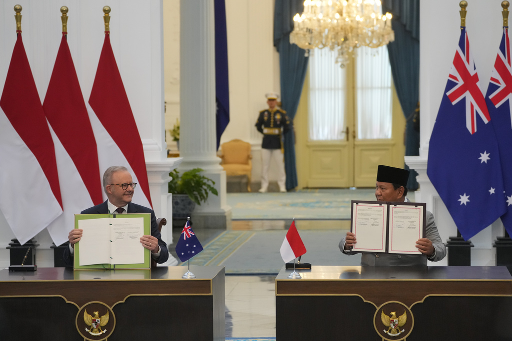 Australian Prime Minister Anthony Albanese, left, and Indonesian President Prabowo Subianto show documents they just signed during their meeting at Merdeka Palace in Jakarta, Indonesia, Friday, Feb. 6, 2026. (AP Photo/Achmad Ibrahim)
