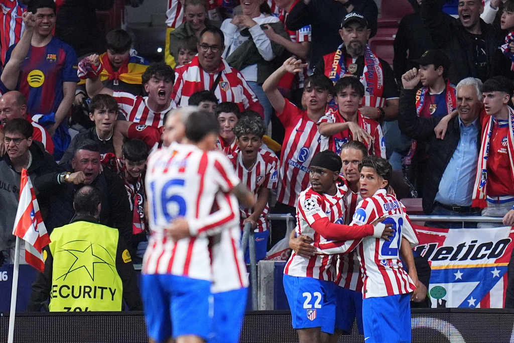 Atletico Madrid's Ademola Lookman celebrates with teammates after scoring his side's opening goal during the Champions League quarterfinal second leg soccer match between Atletico Madrid and Barcelona in Madrid, Spain, Tuesday, April 14, 2026. (AP Photo/Manu Fernandez)