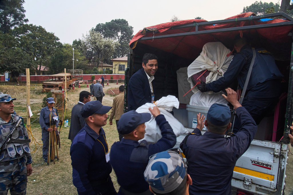 Police carry a ballot box to a vehicle for transport to a counting center after voting ended at a polling station during the parliamentary election in Kathmandu, Nepal, Thursday, March 5, 2026. (AP Photo/Niranjan Shrestha)