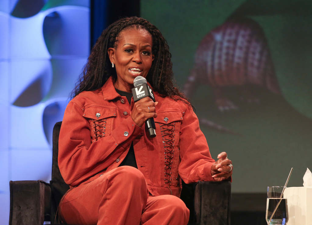 FILE - Former first lady Michelle Obama takes part in a featured session and taping of her new podcast, IMO, with her brother Craig Robinson, not pictured, at the Austin Convention Center during the South by Southwest Conference and Festival on Thursday, March 13, 2025, in Austin, Texas. (Photo by Jack Plunkett/Invision/AP, File)