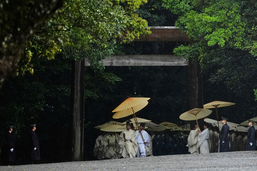 Priests and officials in the Shinto priesthood march as they start Yamaguchisai, a kickoff ceremony of the Shikinen Sengu ritual, which concludes in 2033, at Kotaijingu, also known as Naiku, or the inner sanctuary, of the Ise Jingu shrine complex in Ise, central Japan, Friday, May 2, 2025. (AP Photo/Hiro Komae)