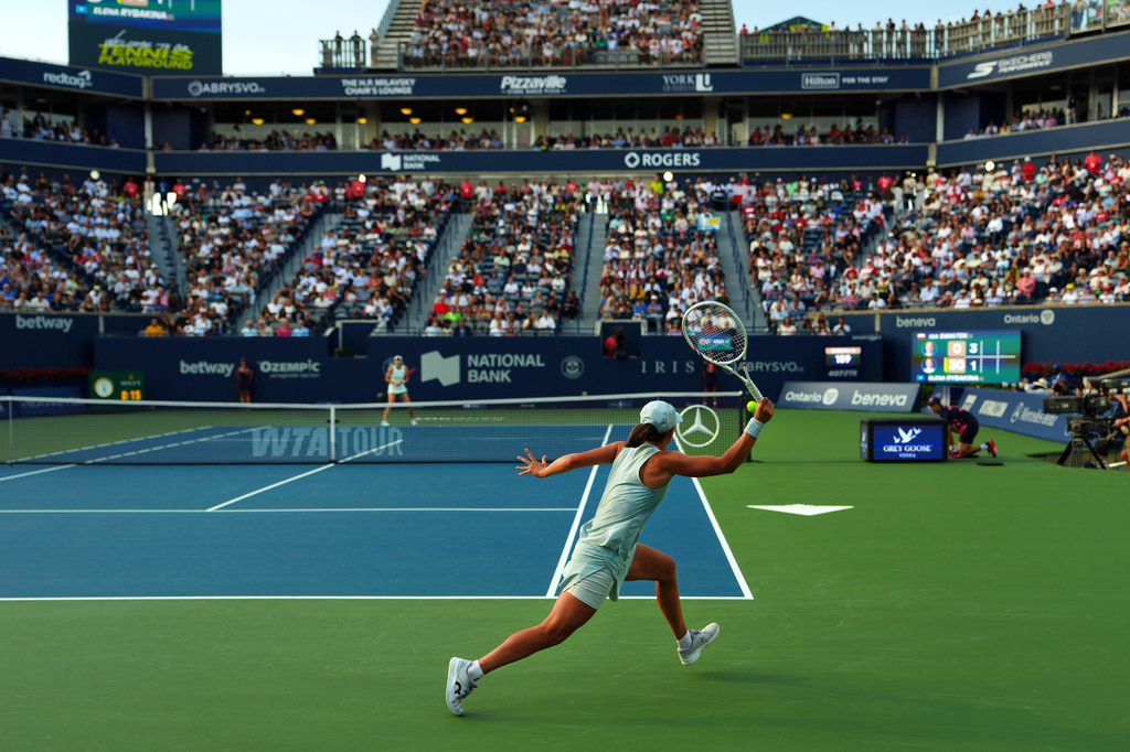 Iga Swiatek, of Poland, returns the ball from Elena Rybakina, of Kazakhstan during a National Bank Open final tennis match, in Toronto, Thursday, Aug. 13, 2026. (Chris Young/The Canadian Press via AP)
