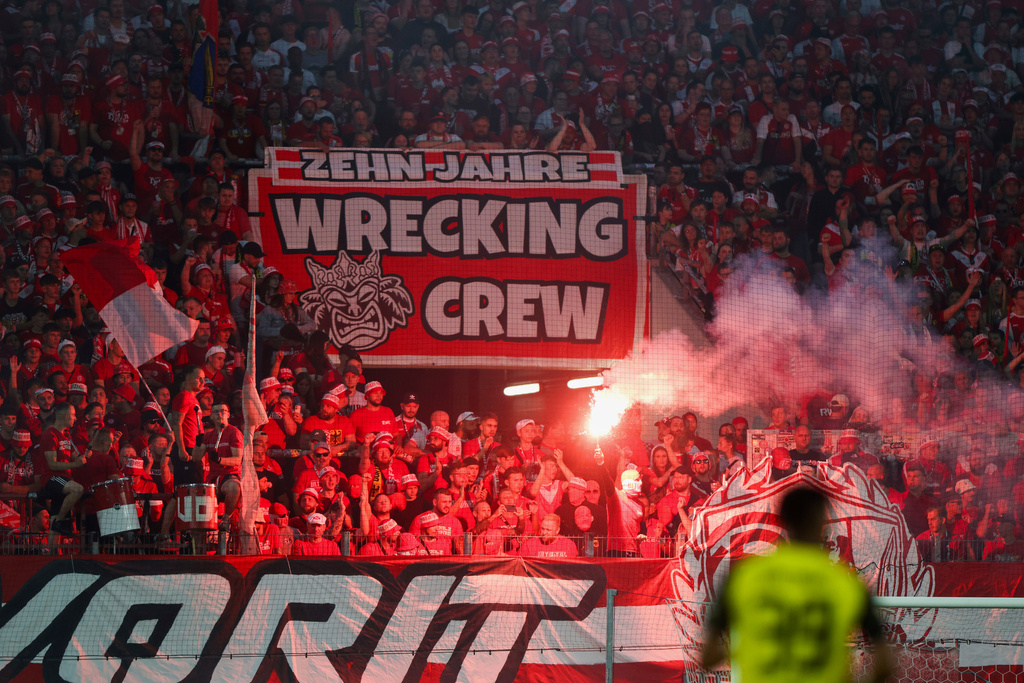 Essen fans set off Bengal fires in the fan block during a German Cup first-round soccer match between Essen and Borussia Dortmund, at Stadion an der Hafenstrasse in Essen, Germany, Monday, Aug. 18, 2025. (Christoph Reichwein/dpa via AP)