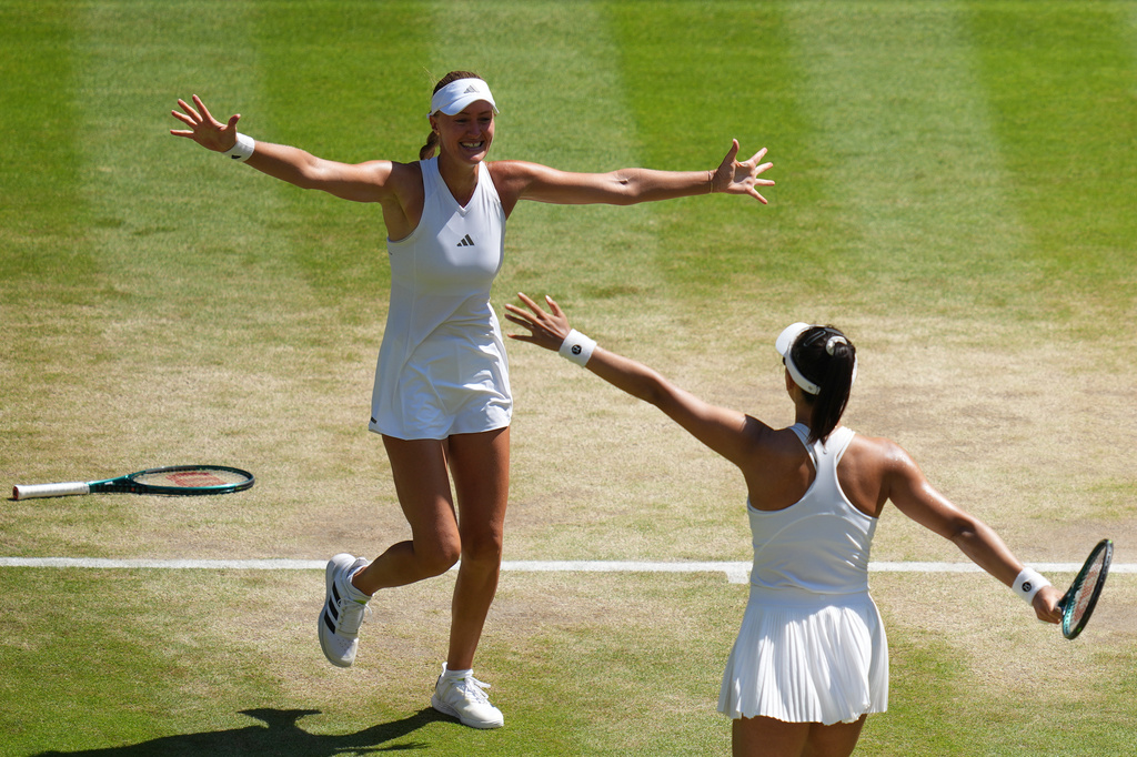 Guo Hanyu of China and Kristina Mladenovic of France, left, react after winning against Luisa Stefani of Brazil and Gabriela Dabrowski of Canada in the women's doubles final at Wimbledon Tennis Championships in London, Sunday, July 12, 2026. (AP Photo/Kirsty Wigglesworth)