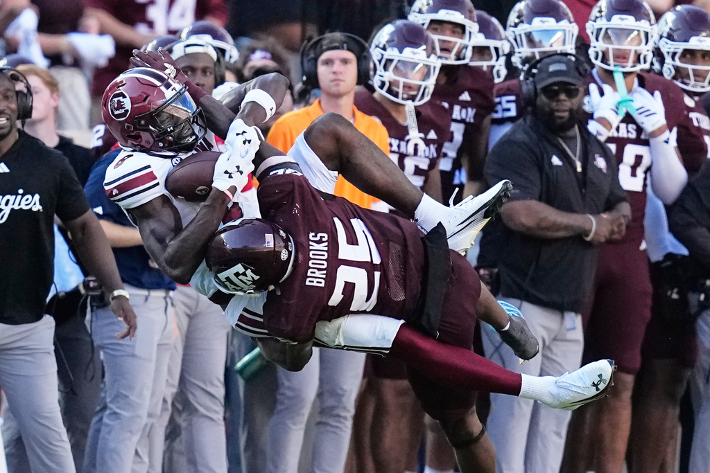 South Carolina wide receiver Nyck Harbor (8) catches a pass as Texas A&M safety Dalton Brooks (25) defends during the second half of an NCAA college football game Saturday, Nov. 15, 2025, in College Station, Texas. (AP Photo/David J. Phillip)