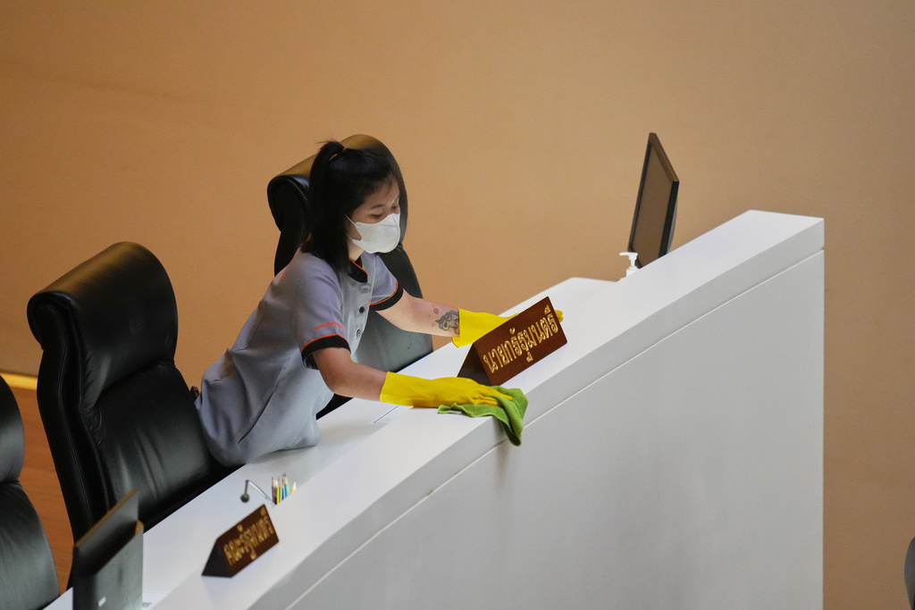 A worker cleans the desk for Thai Prime Minister Anutin Charnvirakul at the parliament in Bangkok, Thailand, Thursday, March 19, 2026. (AP Photo/Sakchai Lalit)