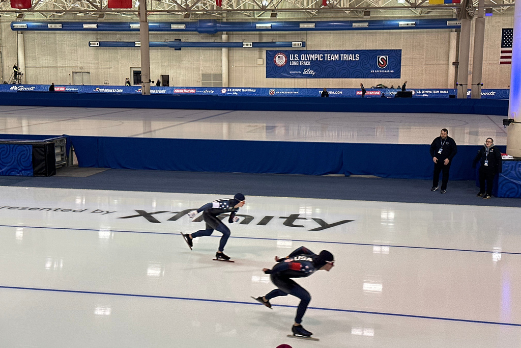 Casey Dawson, of Park City, Utah, right, and Ethan Cepuran, of Glen Ellyn, lllinois, left, compete in the men's 5,000 meters at the U.S. Olympic trials for long track speed skating at the Pettit National Ice Center in Milwaukee, Friday, Jan. 2, 2026. (AP Photo/Howard Fendrich)
