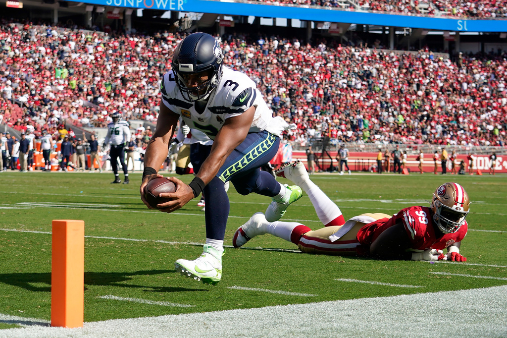 FILE - Seattle Seahawks quarterback Russell Wilson (3) runs for a touchdown past San Francisco 49ers defensive tackle Javon Kinlaw (99) during the second half of an NFL football game in Santa Clara, Calif., Oct. 3, 2021. (AP Photo/Tony Avelar, File)