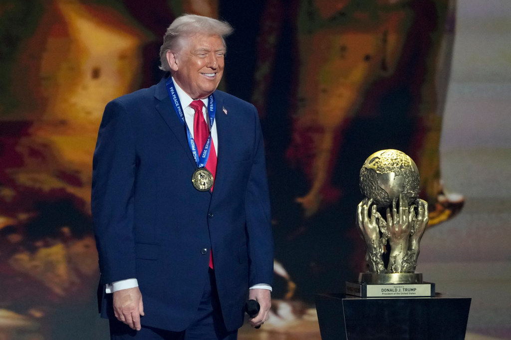 President Donald Trump smiles after being awarded the FIFA Peace Prize during the draw for the 2026 soccer World Cup at the Kennedy Center in Washington, Friday, Dec. 5, 2025. (AP Photo/Chris Carlson)