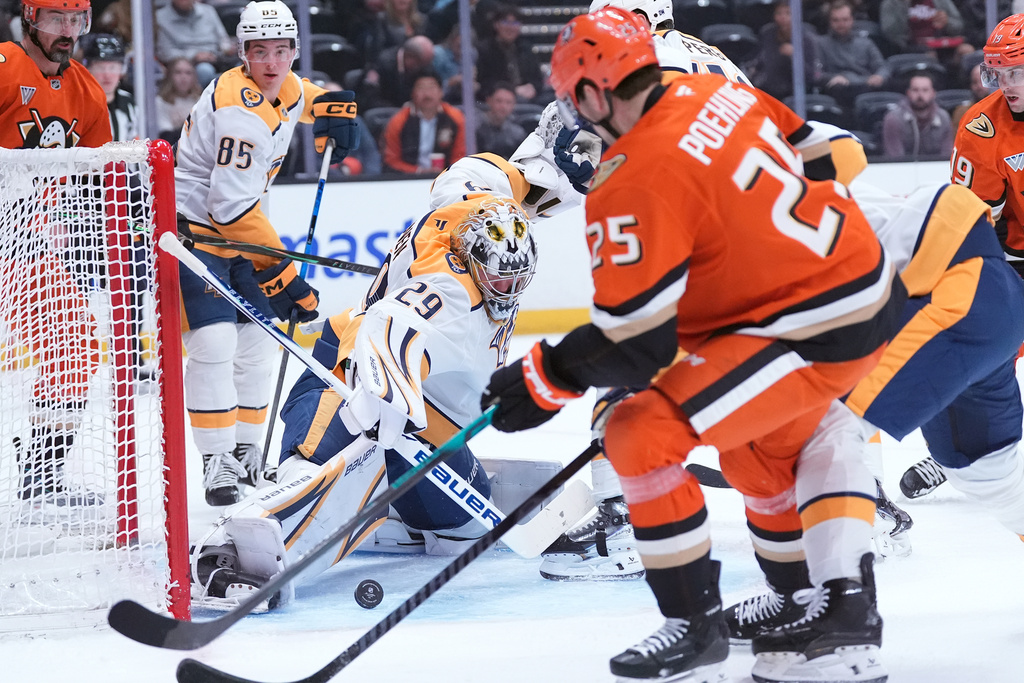 Nashville Predators' goaltender Justus Annunen (29) saves a shot by Anaheim Ducks' center Ryan Poehling (25) during the first period of an NHL hockey game Tuesday, April 7, 2026, in Anaheim, Calif.. (AP Photo/Scott Strazzante)