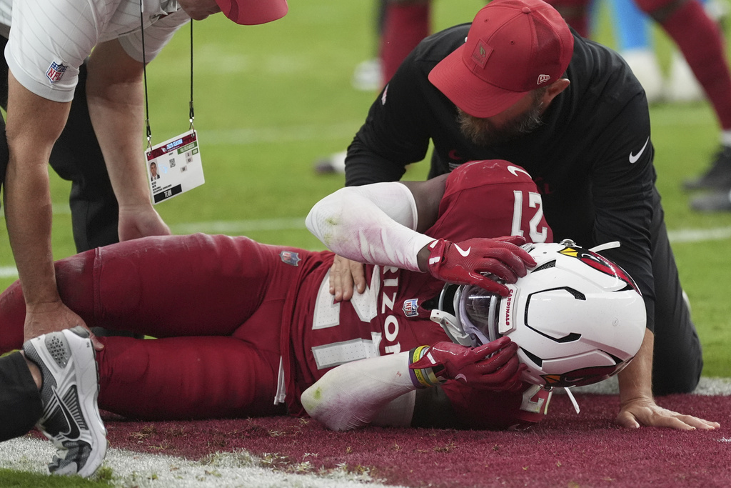 Arizona Cardinals cornerback Garrett Williams (21) is attended to by trainers after an injury against the Carolina Panthers during the second half of an NFL football game, Sunday, Sept. 14, 2025, in Glendale, Ariz. (AP Photo/Ross D. Franklin)