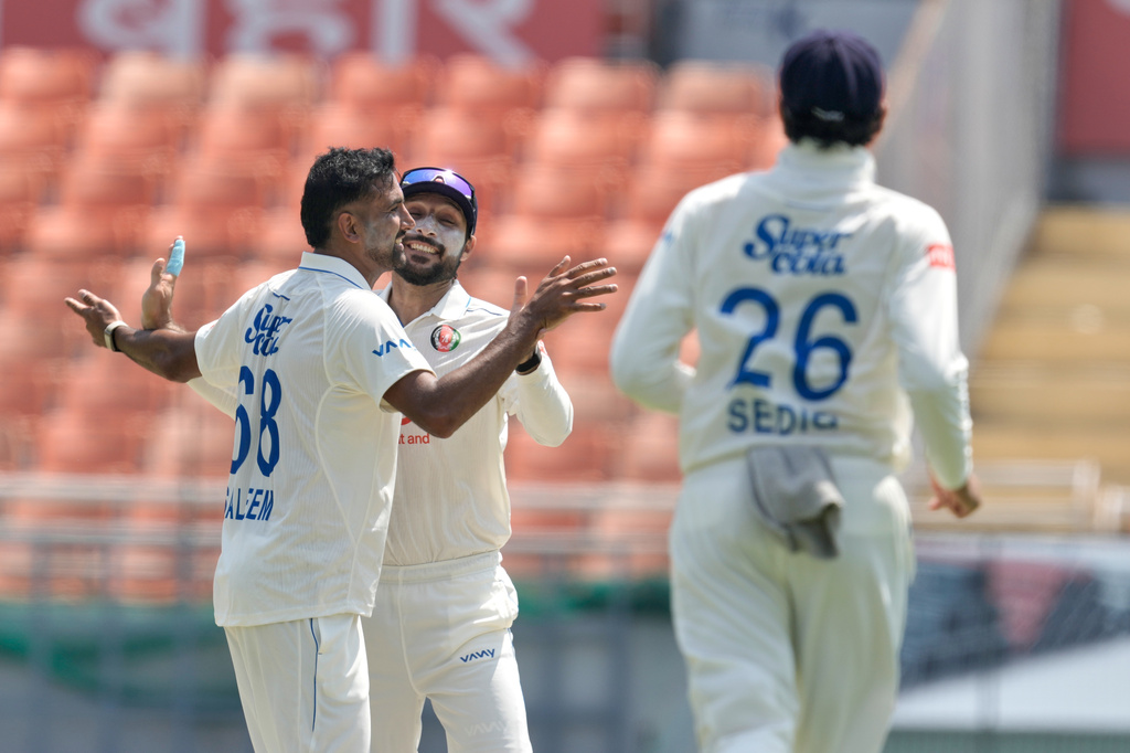 Afghanistan's Mohammad Saleem, left, celebrates the wicket of India's Yashasvi Jaiswal on day one of the cricket test match between Afghanistan and India in New Chandigarh, India, Saturday, June 6, 2026. (AP Photo/Ashwini Bhatia)