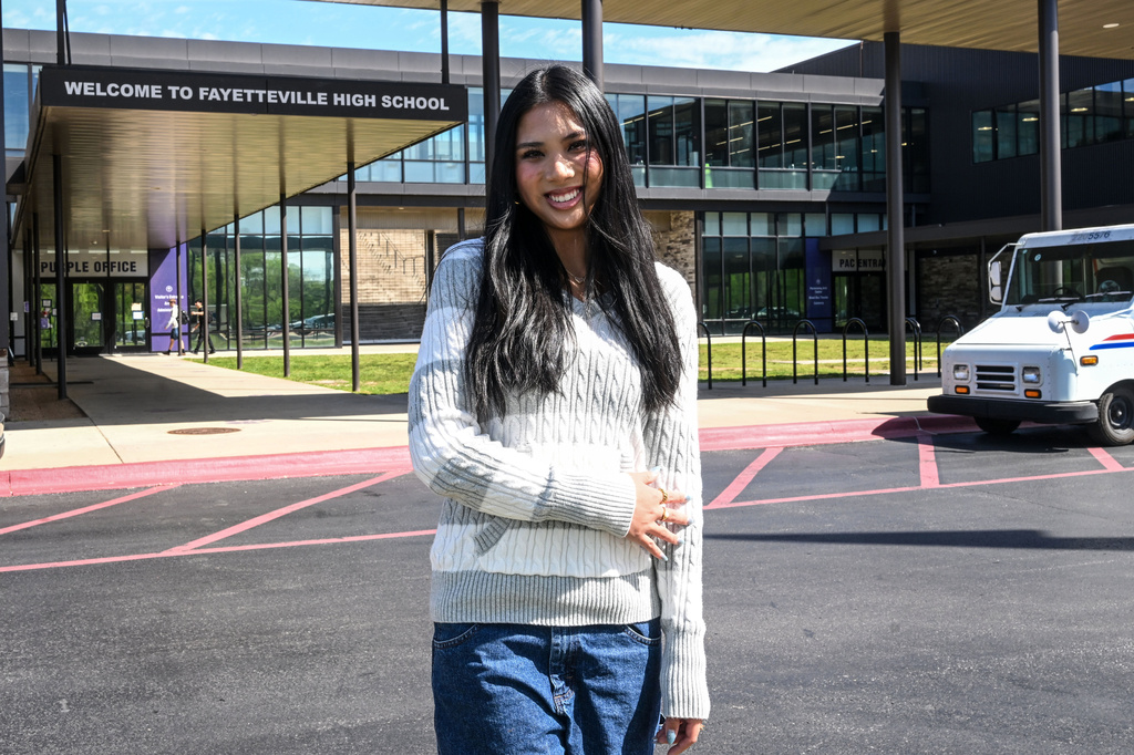 Fayetteville High senior Lily Alder, president of the Young Democrats of Arkansas, in front of Fayetteville High School Tuesday, April, 7, 2026 in Fayetteville, Ark. (AP Photo/Michael Woods)