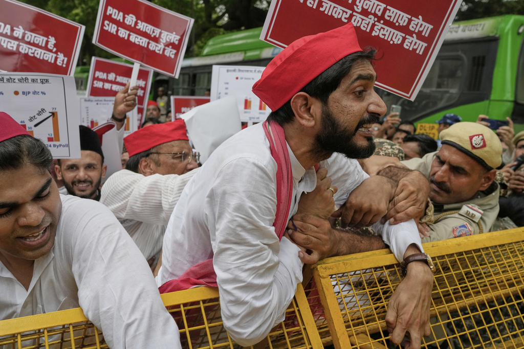 Various opposition parties lawmakers try to break a police barricade during a protest calling for the rollback of a controversial revision of the voter list in one of the country’s poorest states where key elections are scheduled in November, in New Delhi, India, Monday, Aug. 11, 2025. (AP Photo/Manish Swarup)