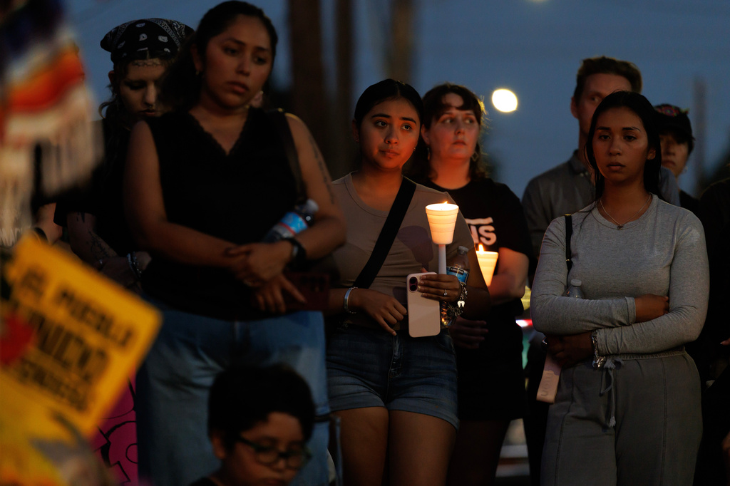 Mourners hold candles during a vigil for Lorenzo Salgado Araujo, a Mexican national fatally shot by a federal immigration agent a day prior, Wednesday, July 8, 2026, in Houston. (AP Photo/Mark Felix)