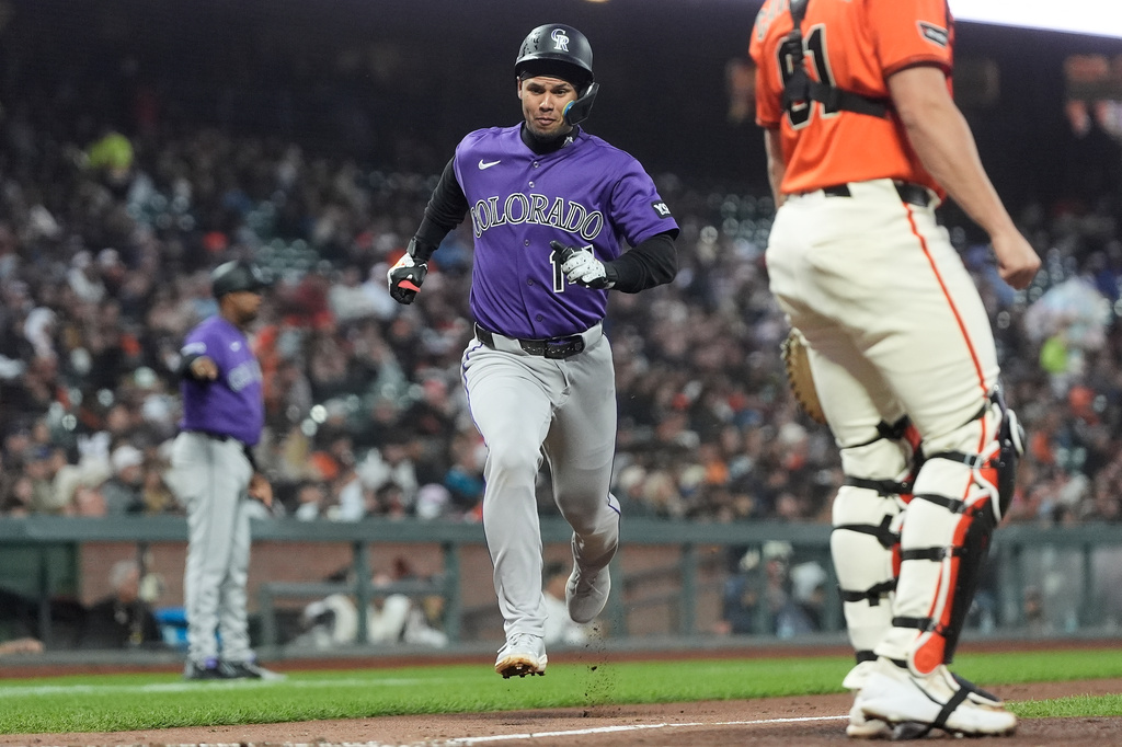 Colorado Rockies' Ezequiel Tovar, middle, runs home to score against the San Francisco Giants during the fifth inning of a baseball game, Friday, July 10, 2026, in San Francisco. (AP Photo/Jeff Chiu)
