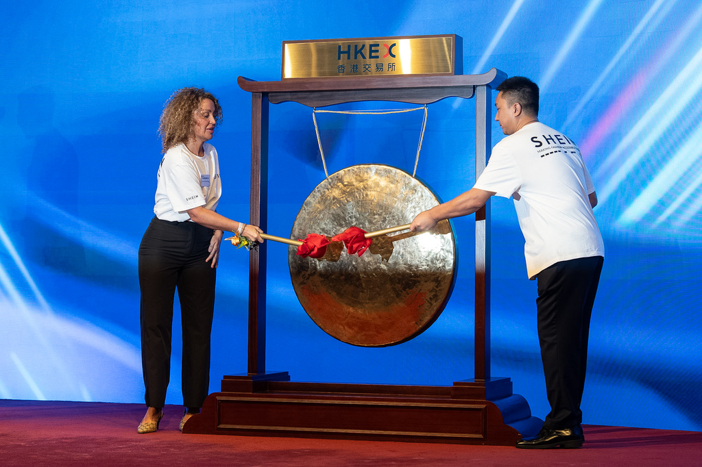 Representatives from fast-fashion online retailer Shein strike the gong at its listing ceremony in Hong Kong, Tuesday, Sept. 1, 2026. (AP Photo/Chan Long Hei)