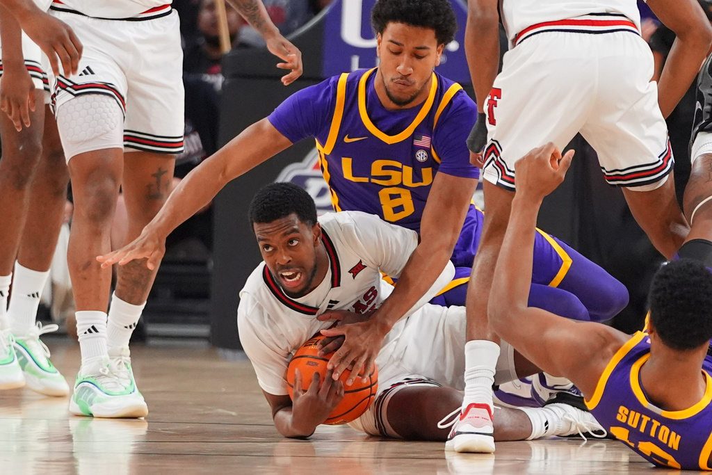 Texas Tech forward Donovan Atwell, center bottom, keeps the ball from LSU forward Pablo Tamba (8) during the first half of an NCAA college basketball game Sunday, Dec. 7, 2025, in Fort Worth, Texas. (AP Photo/LM Otero)