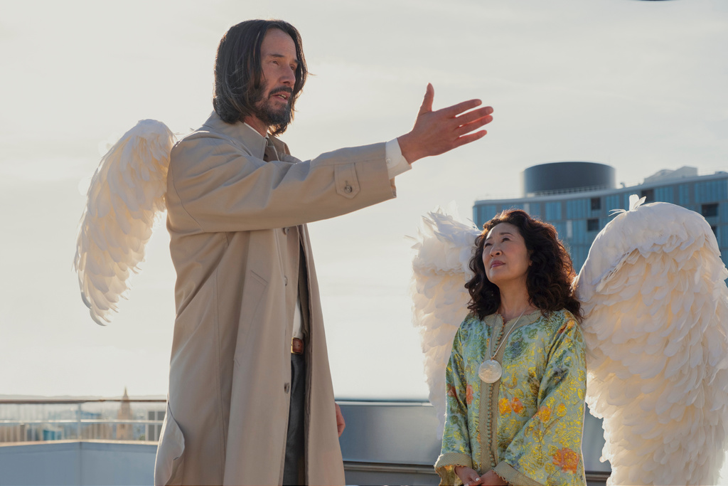 This image released by Lionsgate shows Keanu Reeves, left, and Sandrah Oh in a scene from "Good Fortune." (Eddy Chen/Lionsgate via AP)