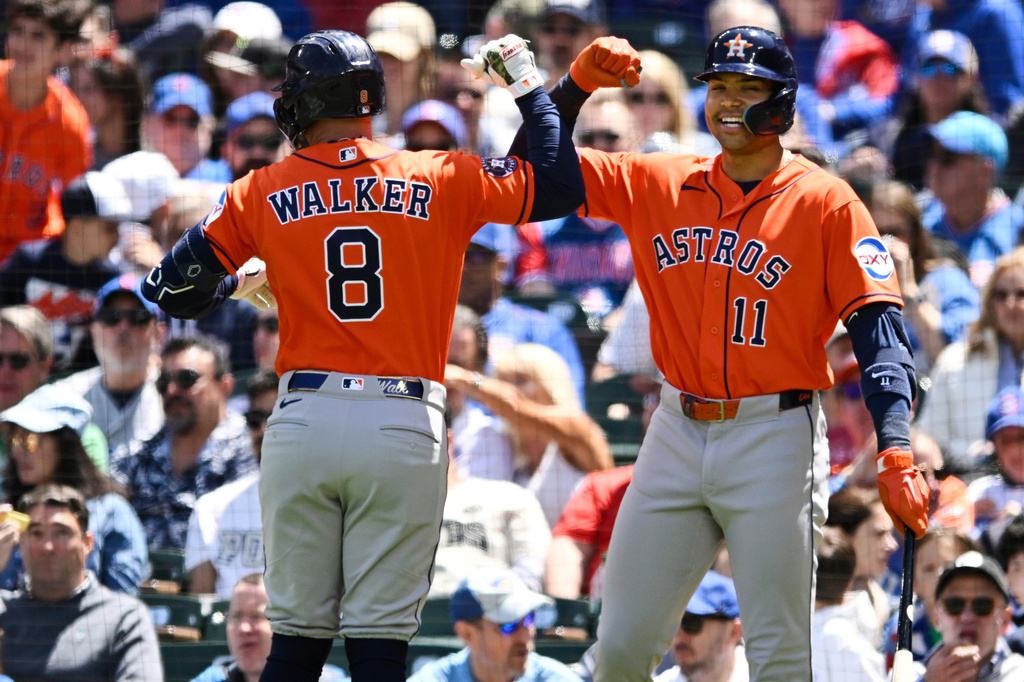 Houston Astros' Christian Walker (8) celebrates with teammate Cam Smith (11) after hitting a two-run home run during the first inning of a baseball game against the Chicago Cubs in Chicago, Saturday, May 23, 2026. (AP Photo/Paul Beaty)
