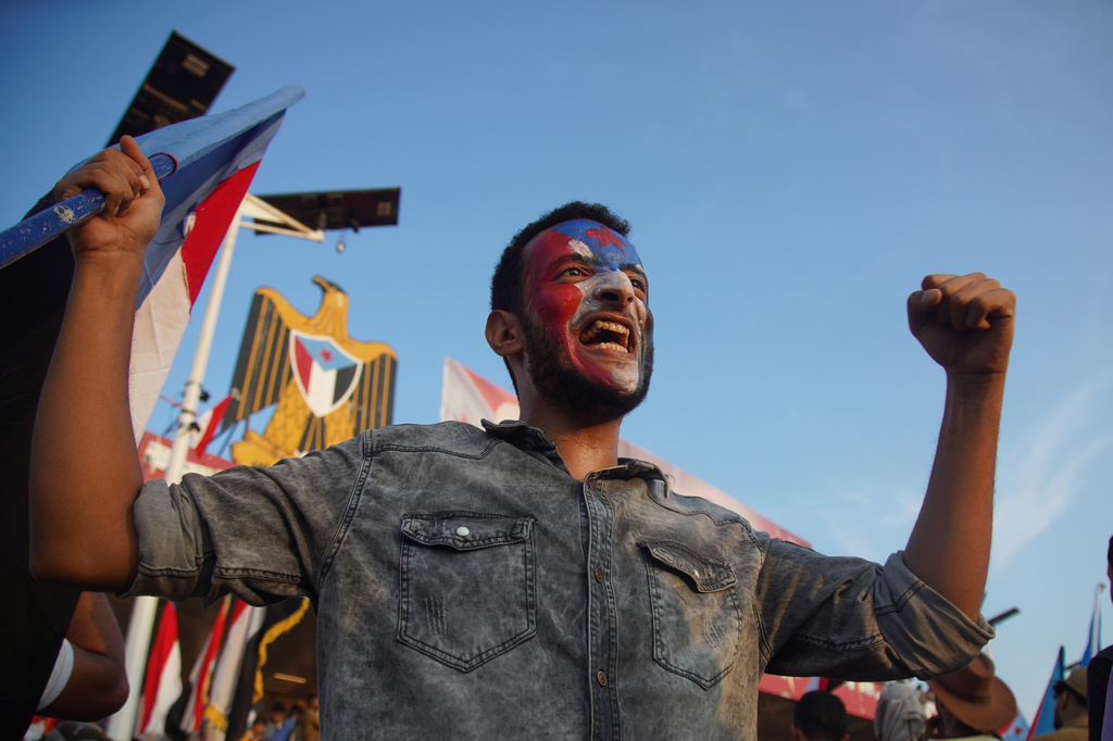 A supporter of the Southern Transitional Council (STC) holds a South Yemen flag during a rally to celebrate the 63rd anniversary of the October 14 Revolution against British colonial rule and respond to calls for mobilization against the Houthi rebels in Aden, Yemen, Wednesday, Oct. 14, 2026. (AP Photo/Abdulnasser Alseddik)