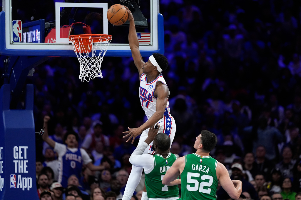 Philadelphia 76ers' Vj Edgecombe, left, goes up for a dunk past Boston Celtics' Jaylen Brown, center, and Luka Garza during the first half of Game 6 in a first-round NBA basketball playoff series Thursday, April 30, 2026, in Philadelphia. (AP Photo/Matt Slocum)