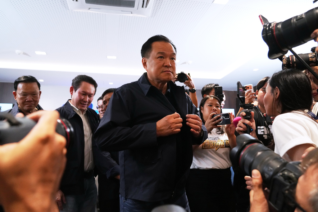 Thailand's Prime Minister and leader of Bhumjaithai Party Anutin Charnvirakul, center, leave after a press conference at the party headquarters following the general election in Bangkok, Sunday, Feb. 8, 2026. (AP Photo/Sakchai Lalit)