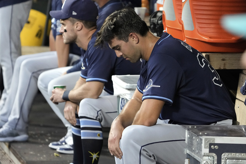Tampa Bay Rays starting pitcher Joe Boyle, right, sits in the dugout after being pulled from a baseball game against the Seattle Mariners during the fourth inning, Saturday, Aug. 9, 2025, in Seattle. (AP Photo/Ted S. Warren)