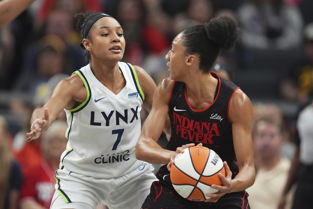 Indiana Fever's Aerial Powers (23) is defended by Minnesota Lynx's Anastasiia Olairi Kosu (7) during the first half of a WNBA basketball game, Tuesday, Sept. 9, 2025, in Indianapolis. (AP Photo/Darron Cummings)
