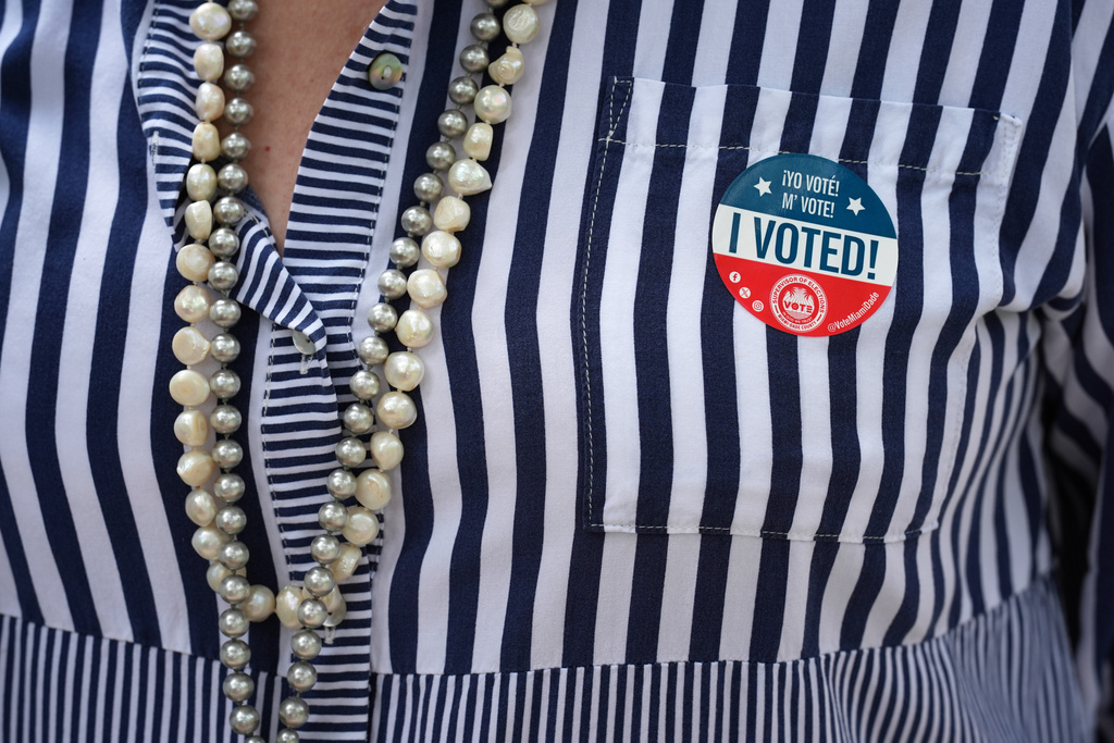 Brickell neighborhood resident Maria Estacio wears an "I Voted" sticker as she leaves a polling place after voting, Tuesday, Nov. 4, 2025, in Miami. (AP Photo/Rebecca Blackwell)