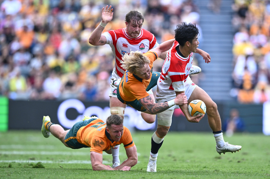 Japan's Haruto Kida is tackled by defenders during a rugby international between Japan and Australia in Townsville, Australia, Saturday, Aug.15, 2026. (Matt Taylor/AAPImage via AP)