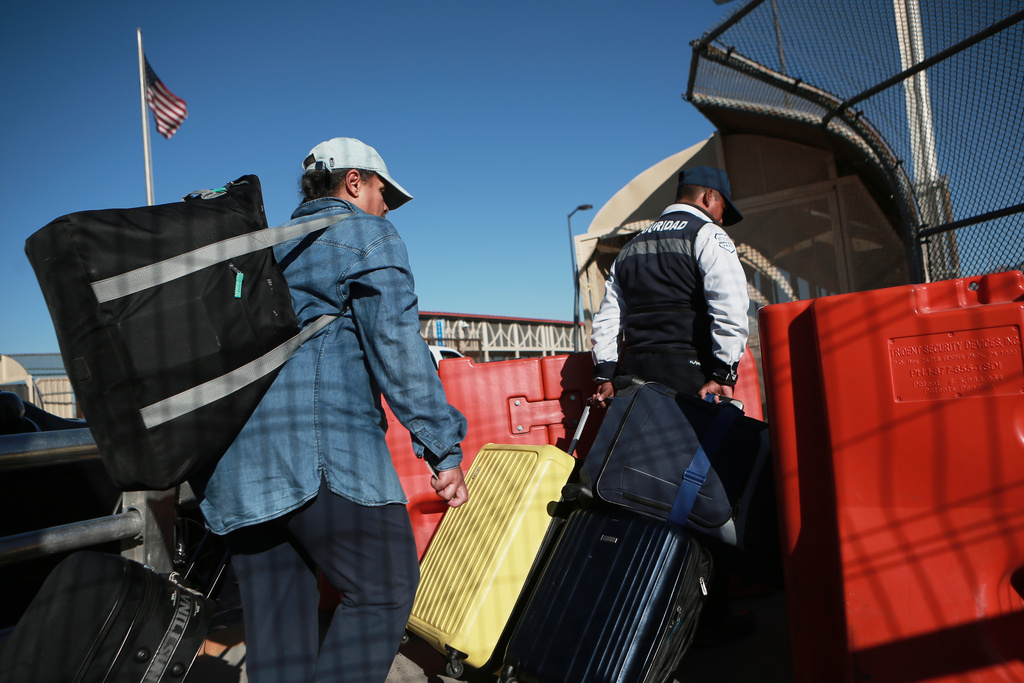 People cross the Paso del Norte International Bridge at the U.S.-Mexico border, in Ciudad Juarez, Mexico, Wednesday Feb. 11, 2026, on the border with El Paso, Texas. (AP Photo/Christian Chavez)