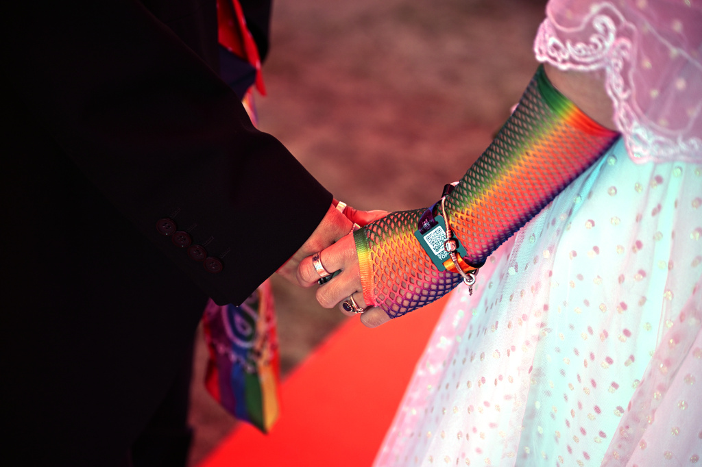 A couple exchange vows during a mass wedding ceremony in an inflatable chapel in Amsterdam, Netherlands, Thursday, Aug. 6, 2026, as part of Pride events celebrating 25 years since the Netherlands became the first country in the world to legalize same-sex marriage. (AP Photo/Mouneb Taim)