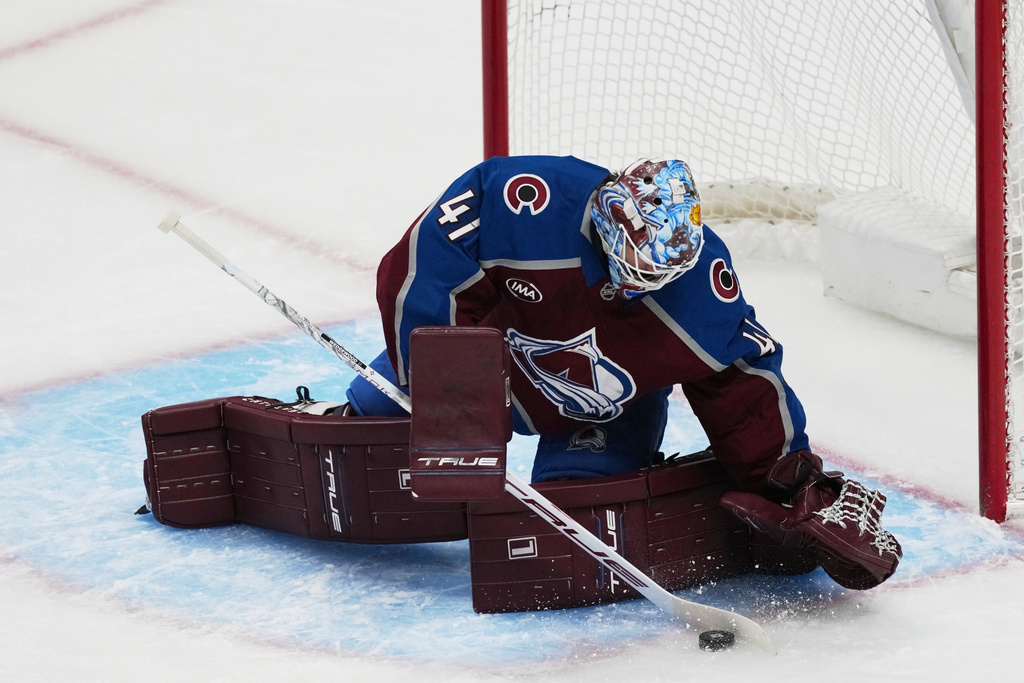 Colorado Avalanche goaltender Scott Wedgewood makes a stick save of a shot from the Anaheim Ducks in the first period of an NHL hockey game Wednesday, Jan. 21, 2026, in Denver. (AP Photo/David Zalubowski)