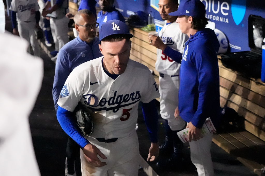 Los Angeles Dodgers' Freddie Freeman leaves the baseball game after falling into the visitors dugout while trying to catch a foul ball hit by Kansas City Royals' Isaac Collins in the eighth inning, Wednesday, Aug. 12, 2026, in Los Angeles. (AP Photo/Mark J. Terrill)