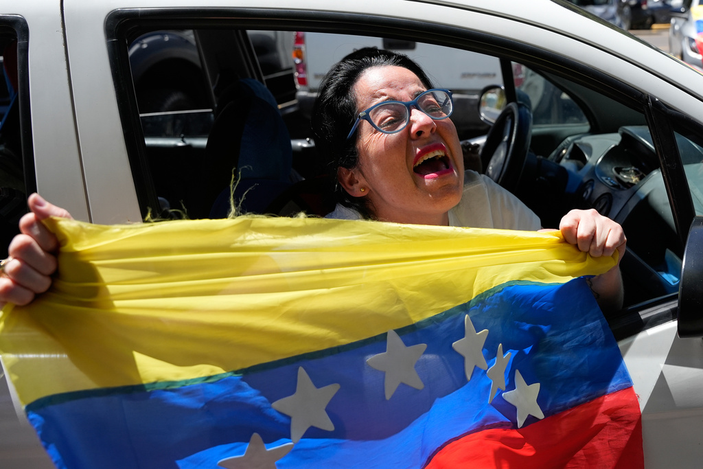 Venezuelans celebrate in Quito, Ecuador, Saturday, Jan. 3, 2026, after U.S. President Donald Trump announced the capture of Venezuelan President Nicolás Maduro. (AP Photo/Carlos Noriega)