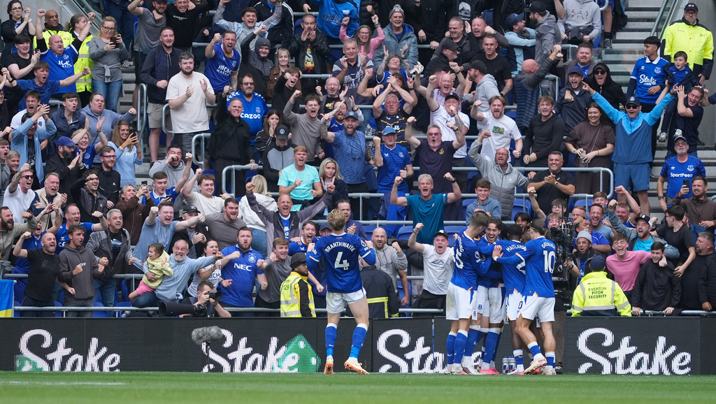 Everton's Tyrique George, hidden, celebrates scoring their side's first goal of the game during the English Premier League soccer match between Everton and Manchester United in Liverpool, England, Sunday, Sept. 6, 2026. (Peter Byrne/PA via AP)