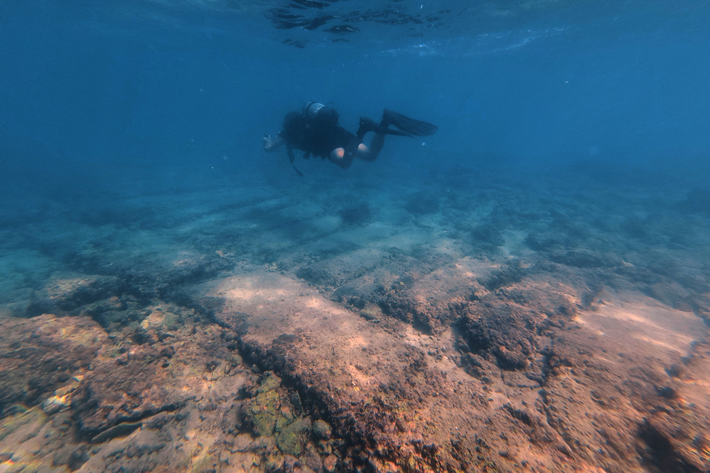 Manager of the Lebanon Diving Center Youssef Jundi passes above an ancient passageway at an archaeological site near the coast in the southern port city of Tyre, Lebanon, Thursday, Sept. 17, 2026. (AP Photo/Bilal Hussein)