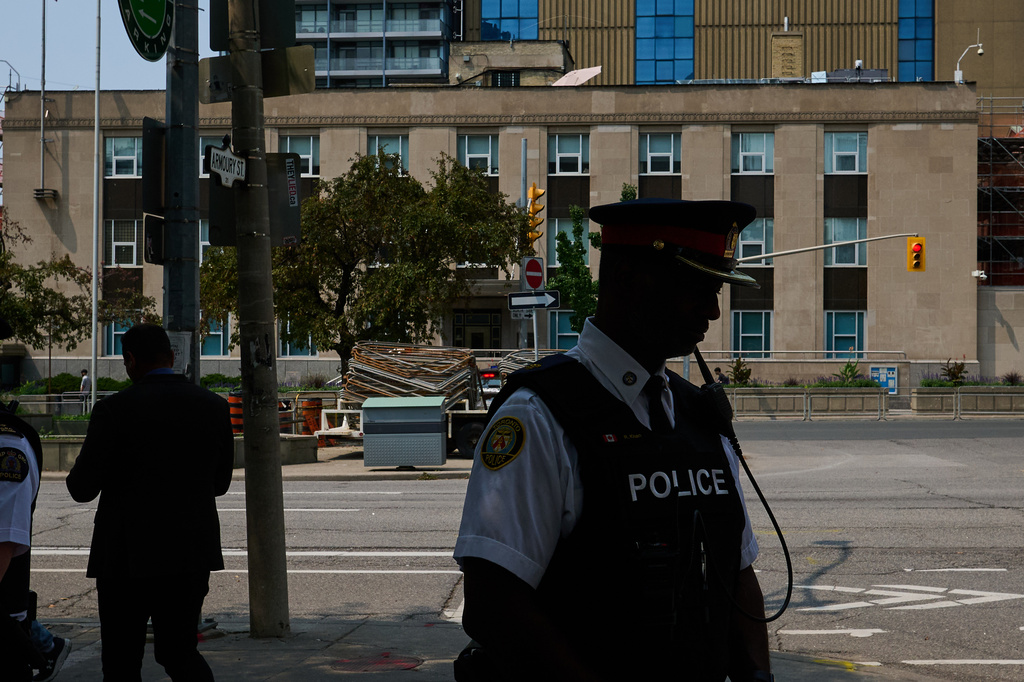 Police leave after speaking to media after a shot was fired at the U.S. Consulate in Toronto, on Monday, July 27, 2026. (Sammy Kogan/The Canadian Press via AP)