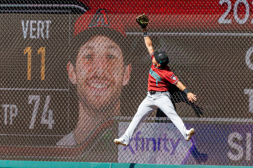 Arizona Diamondbacks left fielder Jorge Barrosa reaches for a home run hit by Philadelphia Phillies' Trea Turner during the sixth inning of a baseball game, Sunday, April 12, 2026, in Philadelphia. (AP Photo/Laurence Kesterson)